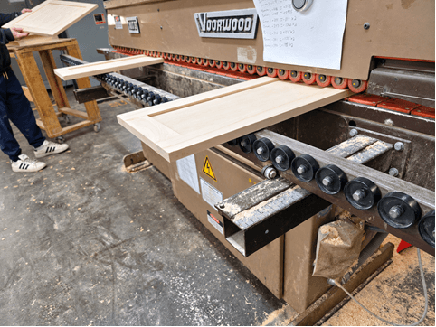 Voorwood machine processing a custom wood cabinet door on the production line